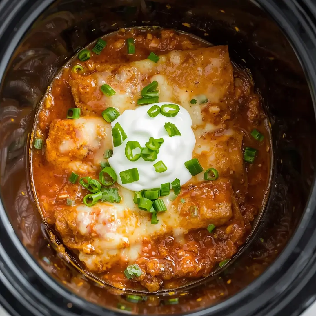Several Crockpot Chicken Enchilada Stuffed Peppers prepared in a slow cooker.