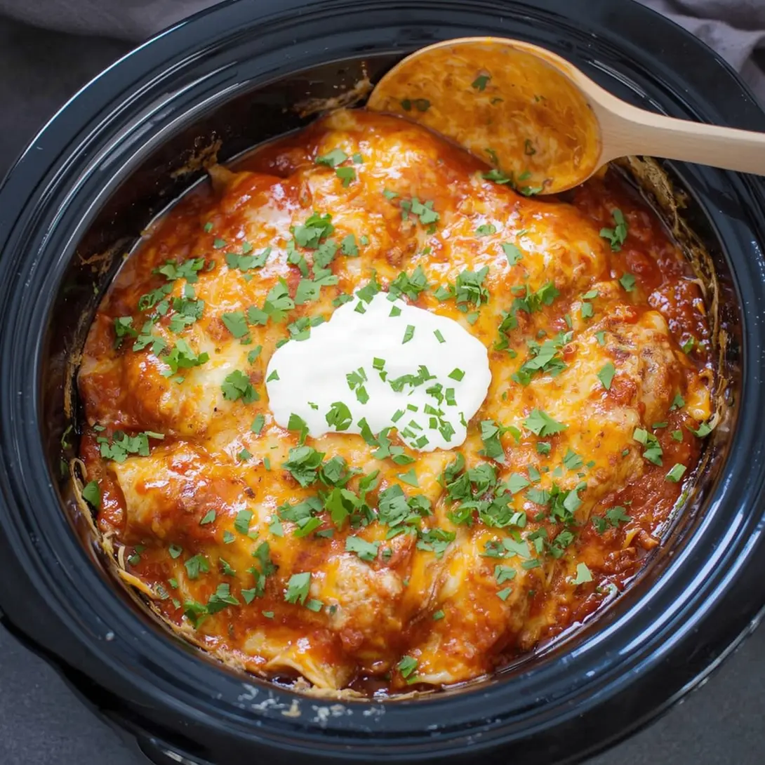 A serving of Crockpot Chicken Quinoa Enchiladas topped with fresh cilantro in a bowl.