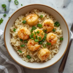 A full bowl of garlic butter shrimp rice, garnished with green onions and parsley