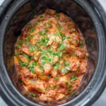 A healthy crockpot chicken burrito bowl with fresh ingredients.