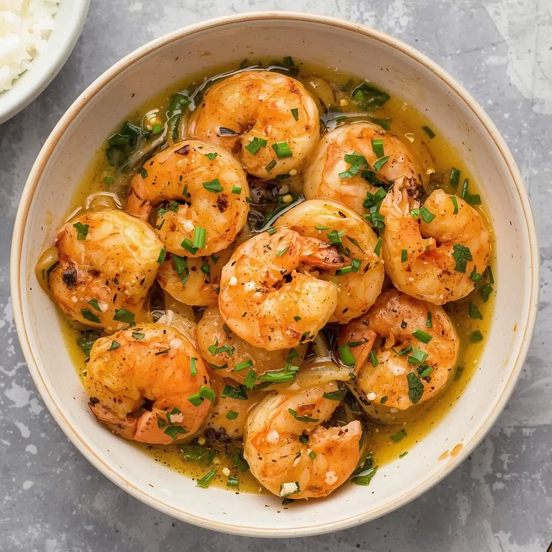A close-up of quick garlic shrimp ramen in a vibrant bowl with broth and chopsticks.