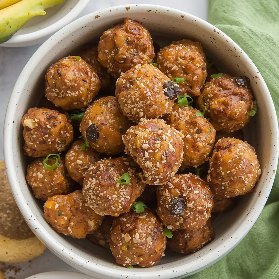 A platter of golden-baked olive cheese balls, ready to serve.
