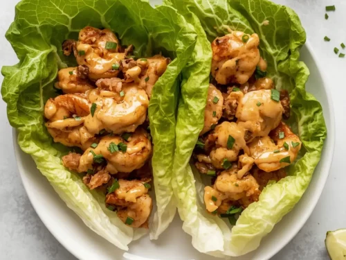 Delicious shrimp lettuce wraps topped with a rich peanut sauce