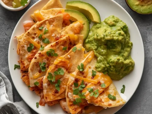 Plate of shrimp quesadillas with a side of avocado salsa.