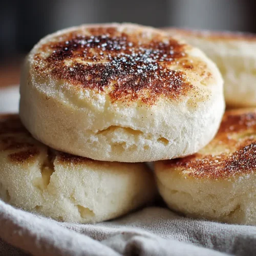 A close-up of freshly baked English muffins with nooks and crannies