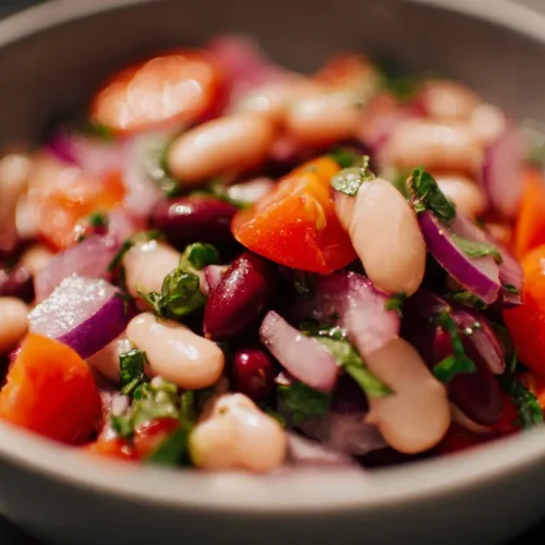 A colorful, freshly prepared easy bean salad in a glass bowl.