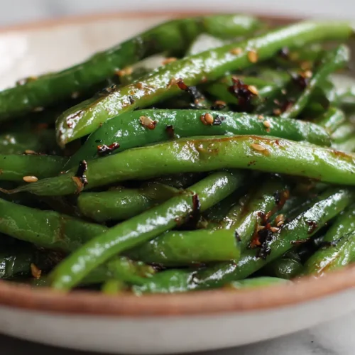 A vibrant dish of tender miso green beans served in a bowl.