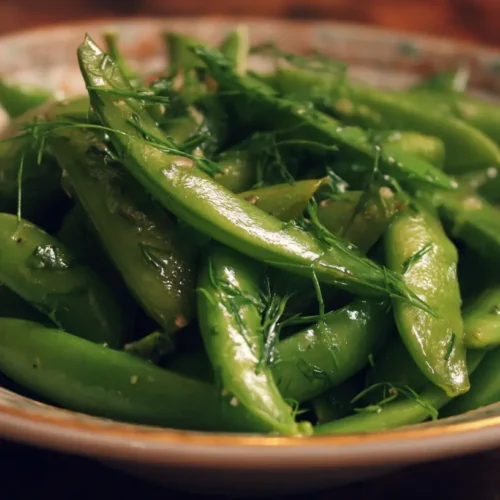 A vibrant snap pea salad with fresh vegetables and a light dressing.