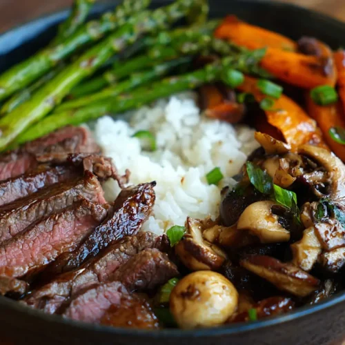 A vibrant hibachi steak bowl filled with colorful vegetables and tender steak pieces.