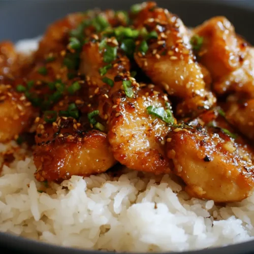Close-up of golden brown honey garlic chicken with a glossy glaze.