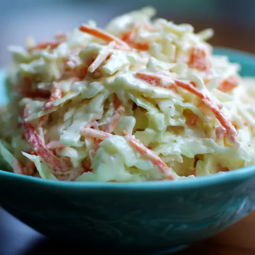 A bowl of fresh creamy coleslaw with shredded cabbage and carrots