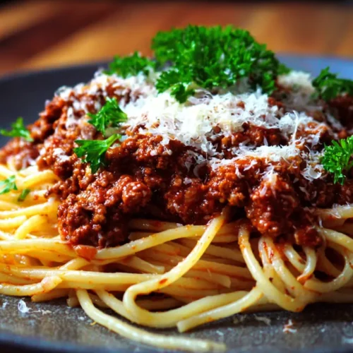 A steaming bowl of traditional spaghetti bolognese, ready to serve.