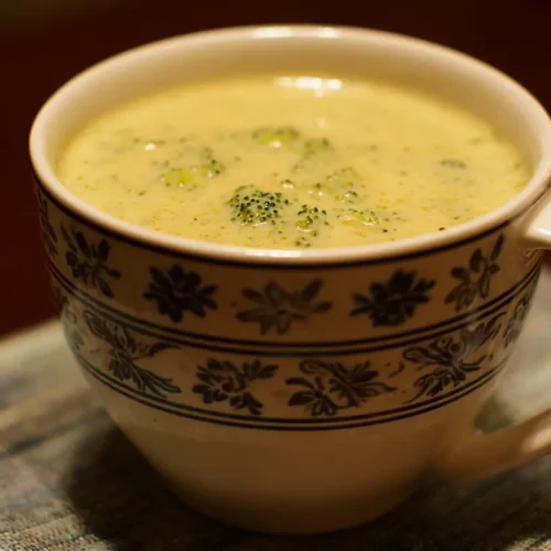 A steaming bowl of creamy broccoli cheddar soup