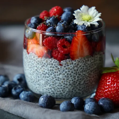 A bowl of healthy chia pudding topped with fresh berries and nuts.