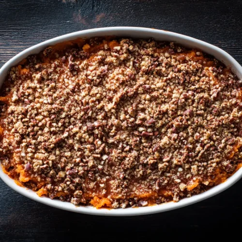 A freshly baked sweet potato casserole with a golden-brown toasted marshmallow topping.